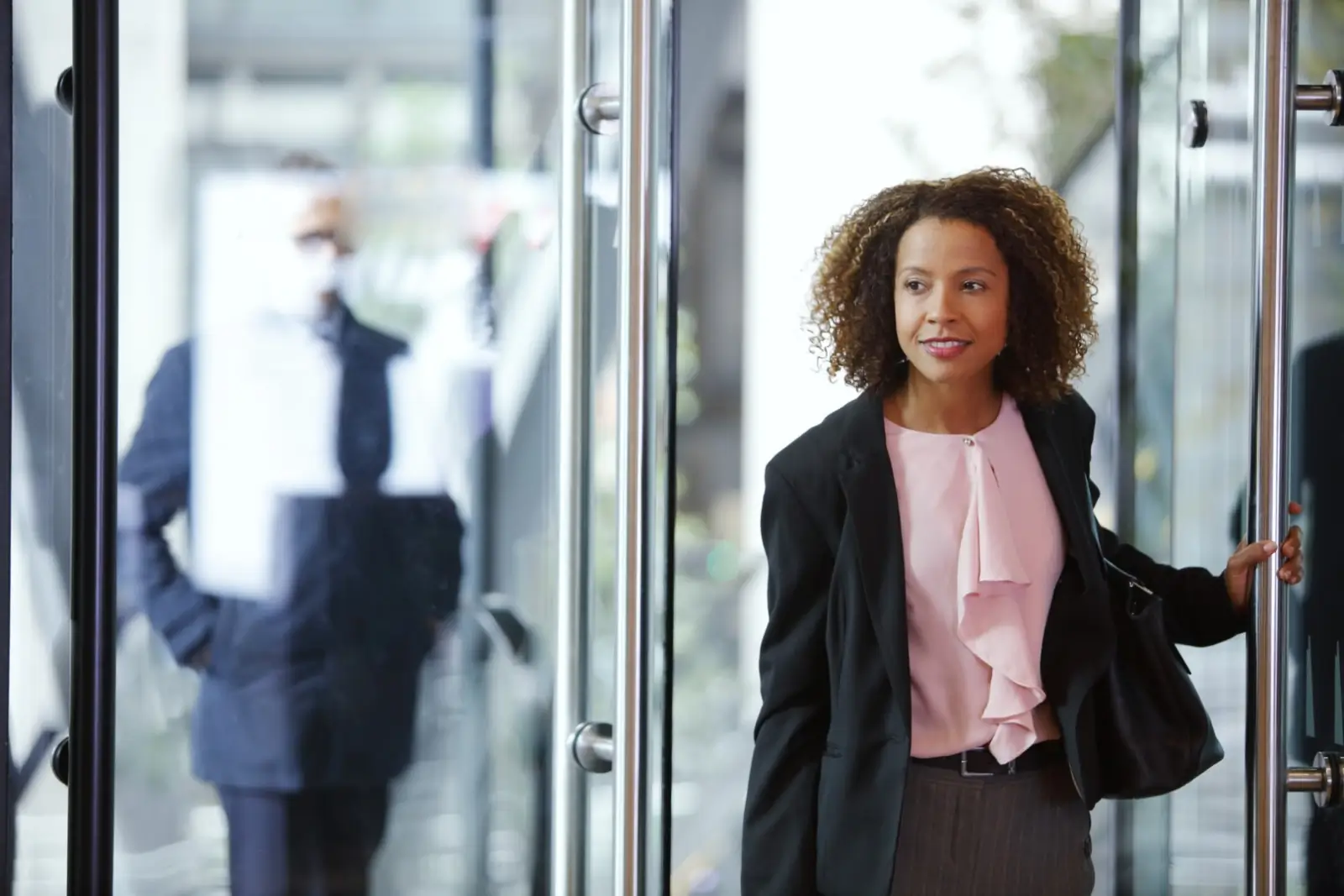 Woman walking into office cropped