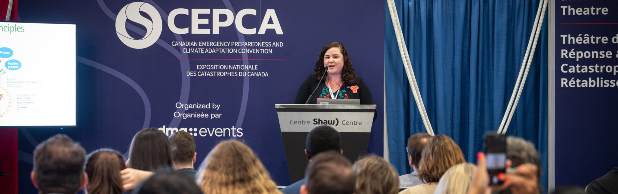 woman standing at a podium in front of a small audience. CEPCA 2024 Conference highlights. • Approaching partnerships with humility, allows climate readiness and community recovery leaders to position themselves to accompany (walk with) Indigenous partners to co-create mutually beneficial solutions